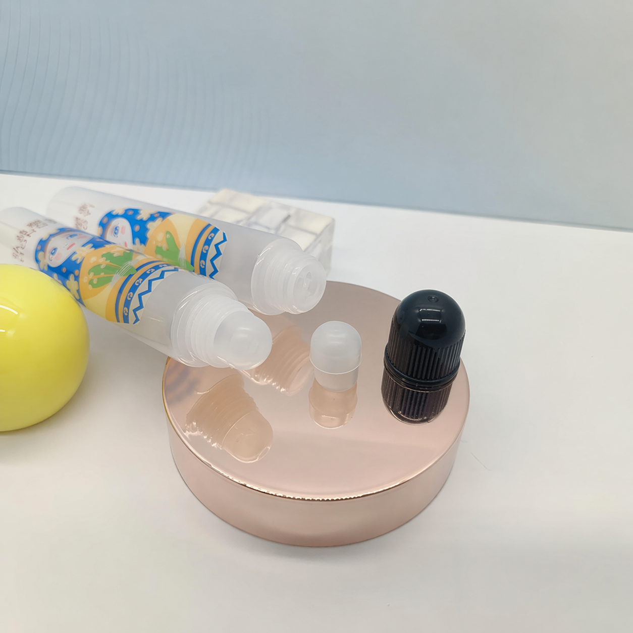 Transparent lip balm tubes and components for small volume lip care packaging